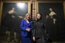 Dutch Minister of Education Jet Bussemaker (L) and French Minister of Culture and Communication Fleur Pellerin pose in front of portraits of Maerten Soolmans and Oopjen Coppit, painted by Rembrandt van Rijn, at the Louvre in Paris on February 1, 2016