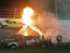 Emergency workers try to put out a fire after Juan Pablo Montoya's car struck the truck during the NASCAR Daytona 500 auto race at Daytona International Speedway in Daytona Beach, Fla., Monday, Feb. 27, 2012. (AP Photo/Bill Friel)