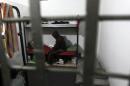 A Palestinian sits in his cell at a prison in Gaza City on March 12, 2013