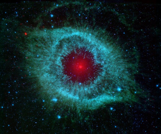 This infrared image from NASA&#39;s Spitzer Space Telescope shows the Helix nebula, a cosmic starlet often photographed by amateur astronomers for its vivid colors and eerie resemblance to a giant eye