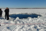 A circular hole in the ice of Chebarkul Lake where a meteor reportedly struck the lake near Chelyabinsk, about 1500 kilometers (930 miles) east of Moscow, Russia, Friday, Feb. 15, 2013. A meteor streaked across the sky and exploded over Russia’s Ural Mountains with the power of an atomic bomb Friday, its sonic blasts shattering countless windows and injuring nearly 1,000 people. (AP Photo)