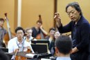 South Korean conductor Chung Myung-whun, right, directs a rehearsal of members of North Korea's Unhasu Orchestra with the Radio France Philharmonic Orchestra in Paris, Tuesday March 13, 2012. Musicians from the Unhasu Orchestra will perform a piece together with Radio France Philharmonic Orchestra, directed by South Korean conductor Chung Myung-whun, in Paris, Wednesday, March 14. (AP Photo/Remy de la Mauviniere)