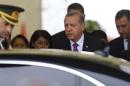 Turkish President Erdogan looks on after arriving at Esenboga Airport in Ankara