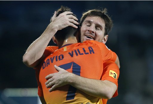 Barcelona's Villa is congratulated by team mate Messi after scoring a goal against Getafe during their Spanish first division soccer match in Getafe