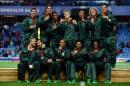 The South African rugby sevens team pose with their gold medals after winning gold in rugby sevens at the at Ibrox Stadium during the 2014 Commonwealth Games in Glasgow on July 27, 2014