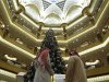 Visitors look at the $11 million Christmas tree in the lobby of the Emirates Palace in Abu Dhabi