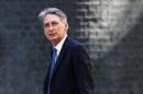 Britain's new Foreign Secretary Philip Hammond leaves 10 Downing Street in central London