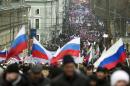 More than ten thousand pro-Kremlin demonstrators many holding Russian flags march in central Moscow, Russia, Sunday, March 2, 2014 to express support for the latest developments in Russian-Ukrainian relations. (AP Photo/Pavel Golovkin)