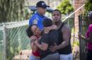 People react to a sudden volley of gunfire near the scene where Garland Tyree barricaded himself in his home after shooting a New York Fire Department lieutenant, in Staten Island, New York