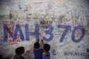 Children write messages of hope for passengers of missing Malaysia Airlines Flight MH370 at Kuala Lumpur International Airport