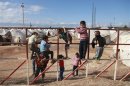 Syrian refugees play at the Reyhanli refugee camp in Hatay province on the Turkish-Syrian border