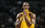 Los Angeles Lakers Kobe Bryant bites his jersey during a break in action against the Boston Celtics in the first half of their NBA basketball game at TD Garden in Boston