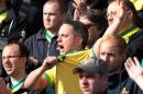 Norwich City fans cheer their team at Carrow Road in Norwich on May 11, 2014