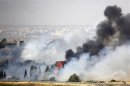 Smoke rises as a fire burns near the Kuneitra border crossing, as seen from the Israeli occupied Golan Heights, close to the ceasefire line between Israel and Syria