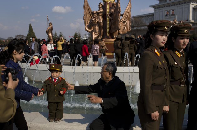 North Korean soldiers and civilians pose for souvenir photos in front of a fountain as they tour the grounds of Kumsusan Palace of the Sun, the mausoleum where the bodies of the late leaders Kim Il Sung and Kim Jong Il lie embalmed, in Pyongyang on Thursday, April 25, 2013. North Korea on Thursday marked the 81st anniversary of the founding of its military, which began as an anti-Japanese militia and now has an estimated 1.2-million troops. (AP Photo/David Guttenfelder)