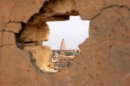 A view of the spiral minaret of Samarra's Great Mosque seen on February 11, 2008 through a wall hit by shellfire