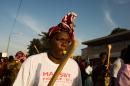 In this photo taken on Monday, Oct. 27, 2014, Woman holding a wooden spoon protest with others during a rally against the longtime president that seeks another term in Ouagadougou, Burkina Faso. Police used tear gas on Tuesday to disperse an opposition protest in Burkina Faso's capital, as tensions increase ahead of a vote this week on whether the country's longtime president can seek another term. (AP Photo/Theo Renaut)