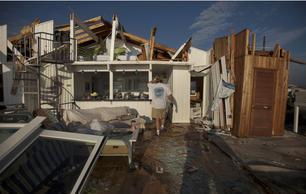 Casey Robinson, and his wife Denise Robinson clean up what is left of their beach house after Hurricane Irene passed Sunday, Aug. 28, 2011 in Virginia Beach, Va. (AP Photo/The Virginian-Pilot,  L. Tod