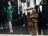 Woman looks at her mobile phone as she stands on New Bond Street in London