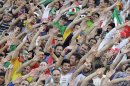 Iranian spectators, cheer, prior to start of Iran and Lebanon soccer match in their Asian qualifiers for 2014 World Cup, at the Azadi (Freedom) stadium in Tehran, Iran, Tuesday, June 11, 2013. Iran won the match 4-0. (AP Photo/Vahid Salemi)