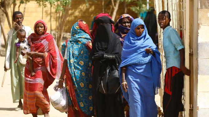 Eritrean refugees walk at a temporary camp in Kassala, in eastern Sudan, on October 22, 2015