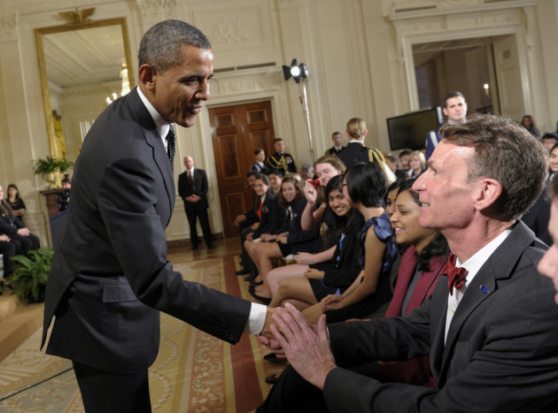 FILE - In this Feb. 7, 2012, file photo, President Barack Obama shakes hands with Bill Nye during an event in the East Room of the White House in Washington. Nye, a mechanical engineer and star of the popular 1990s Television show “Bill Nye The Science Guy,” recently waded into the evolution debate with an online video urging parents not to pass their religious-based doubts about evolution on to their children. (AP Photo/Susan Walsh, File)