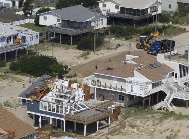 A house damaged by Hurricane Irene is seen in Virginia Beach, Va., Sunday, Aug. 28, 2011.  From North Carolina to New Jersey, Hurricane Irene appeared to have fallen short of the doomsday predictions,
