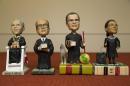 This photo taken Nov. 20, 2013 shows bobblehead dolls representing Supreme Court Justices, from left, David Souter, William Rehnquist, Antonin Scalia, and Ruth Ginsburg, in Washington. They are some of the rarest bobblehead dolls ever produced. They're released erratically. They're given away for free, not sold. And if you get a certificate to claim one, you have to redeem it at a Washington, DC, law office. The limited edition bobbleheads of U.S. Supreme Court justices are the work of law professor Ross Davies, who has been creating them for the past ten years. When finished, they arrive unannounced on the real justices' desks, secreted there by unnamed confederates. And fans will go to some lengths to get one. (AP Photo/Jacquelyn Martin)