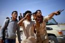 Libya Dawn fighters look at Islamic State militant positions near Sirte