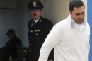 Alaa Mubarak, son of former Egyptian President Hosni Mubarak, leaves the courtroom at the police academy where they were on trial in Cairo