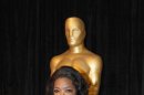 Oprah Winfrey poses with her honorary Oscar at the 84th Academy Awards on Sunday, Feb. 26, 2012, in the Hollywood section of Los Angeles. (AP Photo/Chris Carlson)