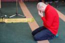 A man cries while he prays at the Quebec Islamic Cultural Centre in Quebec City