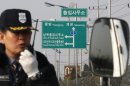 A South Korean security guard works to turn back vehicles as they were refused to enter to Kaesong, North Korea, at the customs, immigration and quarantine office in Paju, South Korea, near the border village of Panmunjom, Thursday, April 4, 2013. North Korea on Wednesday barred South Korean workers from entering a jointly run factory park just over the heavily armed border in the North, officials in Seoul said, a day after Pyongyang announced it would restart its long-shuttered plutonium reactor and increase production of nuclear weapons material. (AP Photo/Ahn Young-joon)