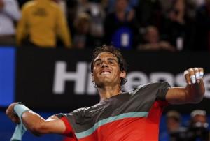 Nadal of Spain throws his sweatbands into the crowd as he celebrates defeating Federer of Switzerland in their men&#39;s singles semi-final match at the Australian Open 2014 tennis tournament in Melbourne