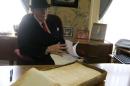 Dudley Martin looks at handwritten manuscripts written by Robert Stroud at his home in Springfield, Missouri