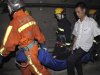 Rescue workers carry an injured passenger in the subway tunnel from a train involved in a collision in Shanghai on Tuesday Sept. 27, 2011.   A Shanghai subway train rear-ended another Tuesday, injuring more than 40 people in the latest trouble for the rapidly expanded transportation system in China's commercial center. (AP Photo) CHINA OUT