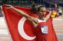 FILE - In this Friday, Aug. 10, 2012 file photo, Turkey's Asli Cakir Alptekin celebrates her gold medal in the women's 1500-meter during the athletics in the Olympic Stadium at the 2012 Summer Olympics, London. The international track and field association has appealed the Turkish Athletics Federation's decision to clear Olympic 1,500-meter champion Asli Cakir Alptekin of doping, and has re-imposed her ban, it was reported on Thursday, Feb. 13, 2014. The TAF cleared Alptekin in December, saying it found no violations of doping rules by the 28-year-old, who won gold at the 2012 London Olympics. (AP Photo/Lee Jin-man, File)