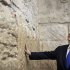 File photo of Israel's Prime Minister Netanyahu touching the stones of the Western Wall in Jerusalem's Old City