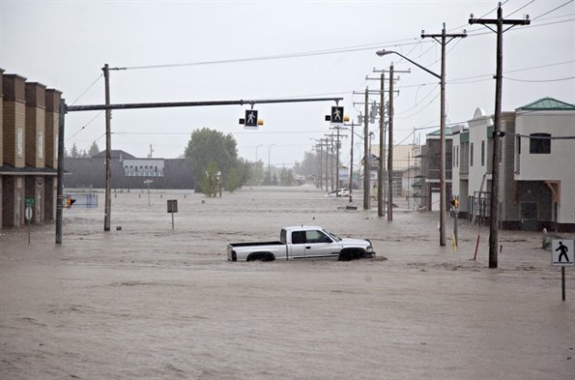 A lone truck sits submerged in the flood waters near downtown High River, Alta. on June 20, 2013 after the Highwood River overflowed its banks. THE CANADIAN PRESS/Jordan Verlage