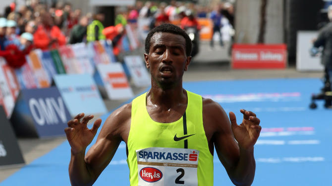 Sisay Lemma of Ethiopia crosses the finish line to win the Vienna city marathon, in Vienna  Austria, on Sunday, April 12, 2015. (AP Photo /Ronald Zak)