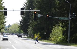 A pedestrian crosses Cooper Pt. Rd., Thursday, May &hellip;