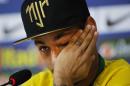 Brazil's Neymar wipes a tear during a press conference at the Granja Comary training center in Teresopolis, Brazil, Thursday, July 10, 2014. The Brazilian soccer star is back on his feet after suffering a broken vertebrae during a World Cup soccer match against Colombia. Brazil will be disputing a third place finish, without its star on Saturday. (AP Photo/Leo Correa)