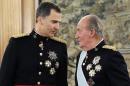 Spain's King Juan Carlos, right, talks to his son the Spain's newly crowned King Felipe VI