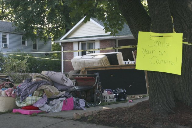 Contents from a home flooded by Hurricane Irene sit in the front yard with a warning sign, Wednesday, Aug. 31, 2011 in Washingtonville, N.Y. Irene destroyed 500 to 600 homes and thousands of acres of 