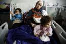 Um Yousef and her two young daughters recover in an Irbil hospital after they were badly injured in a mortar attack outside their home in Mosul, Iraq Sunday Jan. 15, 2017. As Iraqi forces secure a series of swift gains, civilian casualties in the Mosul operation are increasing and doctors at nearby hospitals say they are operating above capacity. (AP Photo/Susannah George)