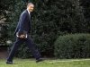 President Barack Obama looks to the media as he walks to the Oval Office of the White House as he returns from greeting members of the staff, Tuesday, Dec. 18, 2012, in Washington. (AP Photo/Carolyn Kaster)