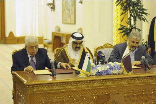 Palestinian President Abbas and Hamas leader Meshaal sit on either side of Qatar's Emir Sheikh Hamad as they sign an agreement in Doha