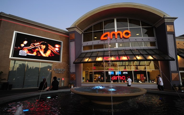 A couple watch a big screen outside an AMC cinema in Los Angeles on May 22, 2012