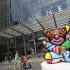 Pedestrians walk past "The Best Buddies Friendship Bear" a sculpture by Brazilian artist Romero Britto on display outside the Time Warner Center, Tuesday, Aug. 2, 2011, in New York. Media conglomerate Time Warner said Wednesday, Aug. 3, its second-quarter net income grew, thanks to higher revenue from its TV channel business and movies such as "The Hangover Part II." (AP Photo/Mary Altaffer)