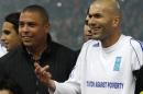 UNDP Goodwill ambassador Zidane of France gestures next to Brazilian Ronaldo before the eighth "Match Against Poverty" soccer match in Piraeus